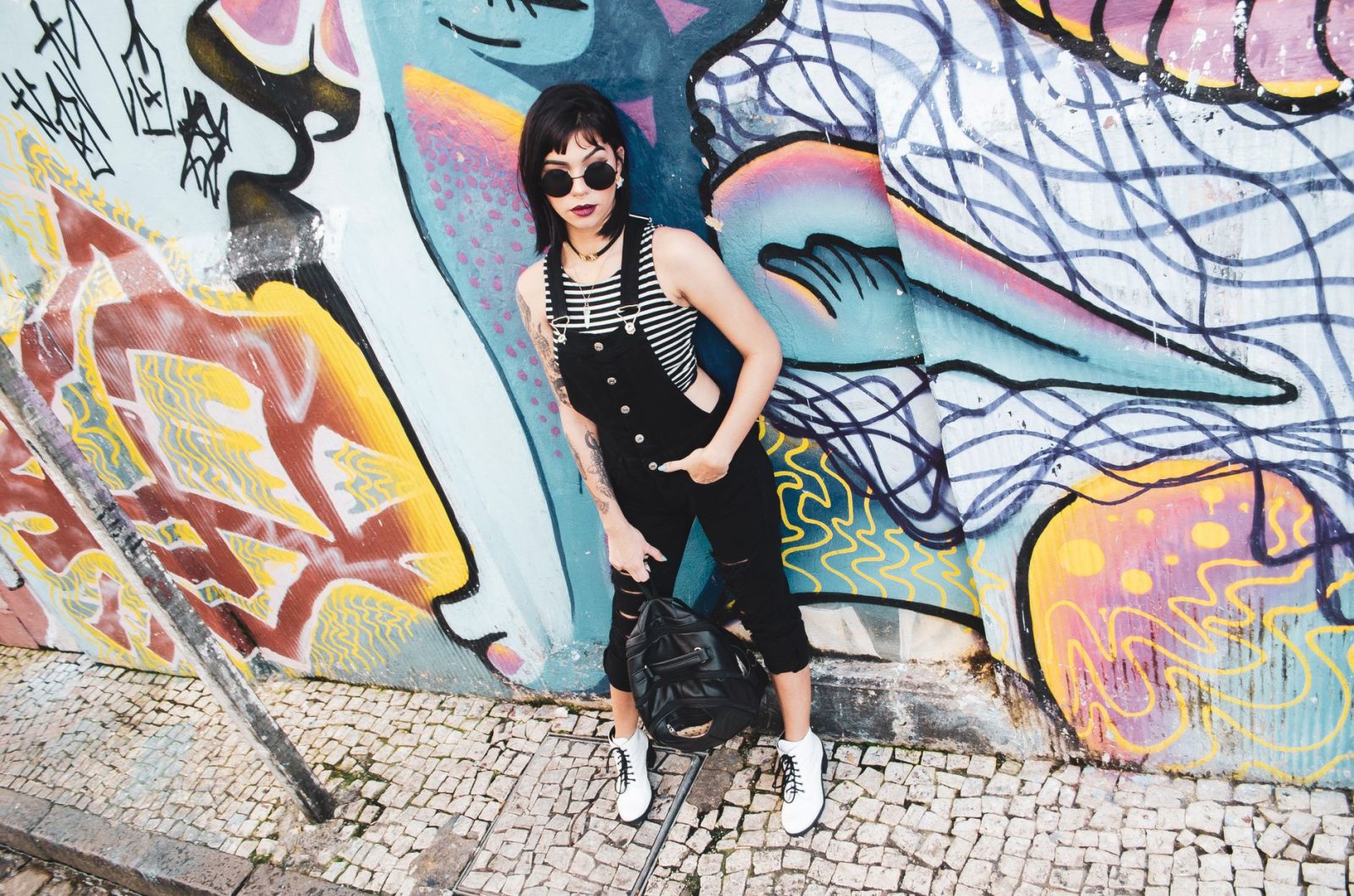 Black emo pants styling guide showcasing gothic alternative fashion outfit combinations and accessories